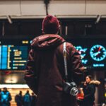 person looking up to the flight schedules