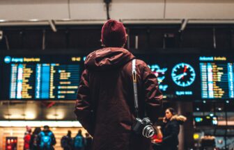 person looking up to the flight schedules