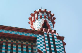 a clock on top of a building with a sky background