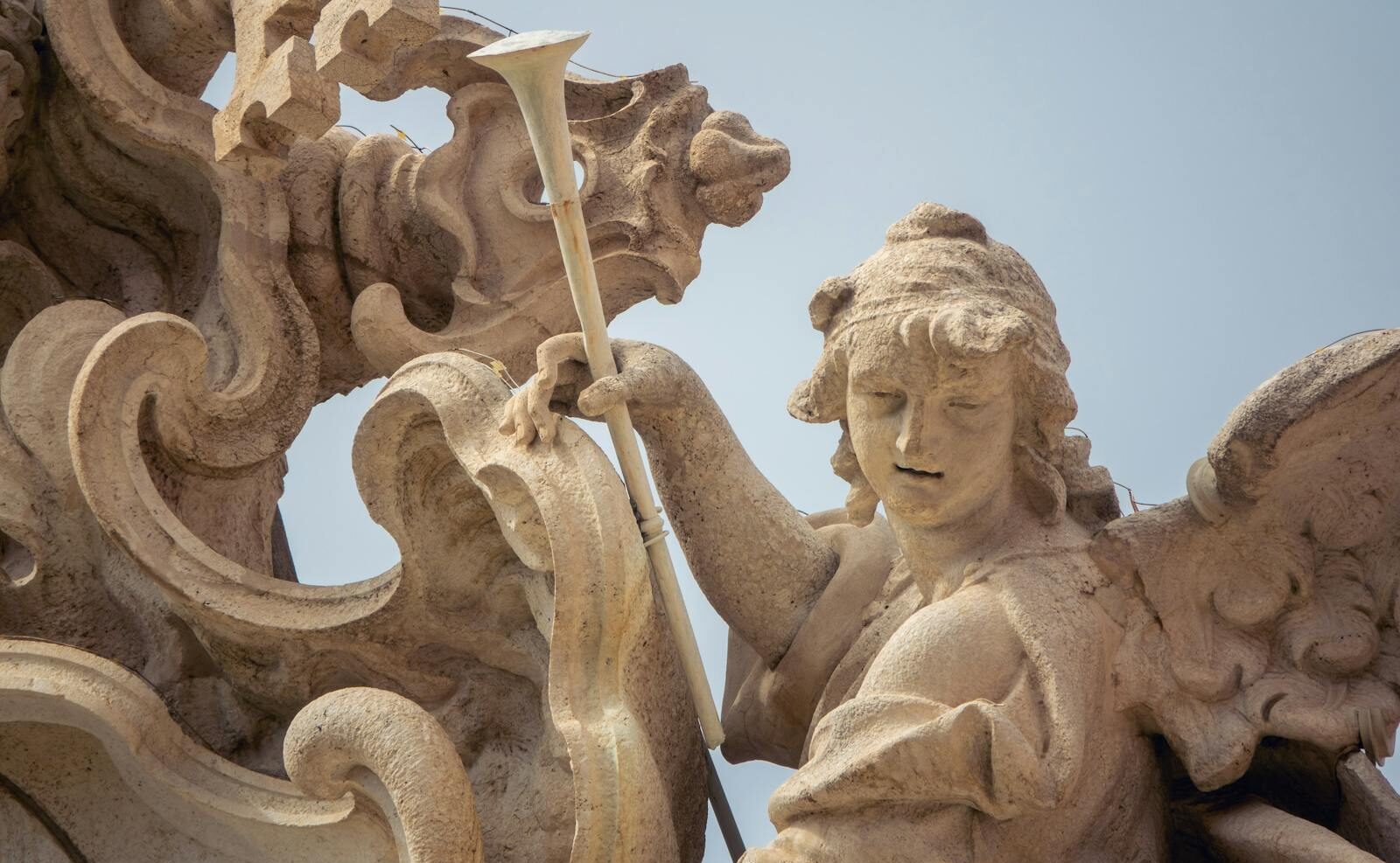 Close-up of an angel sculpture in Rome showcasing intricate craftsmanship.