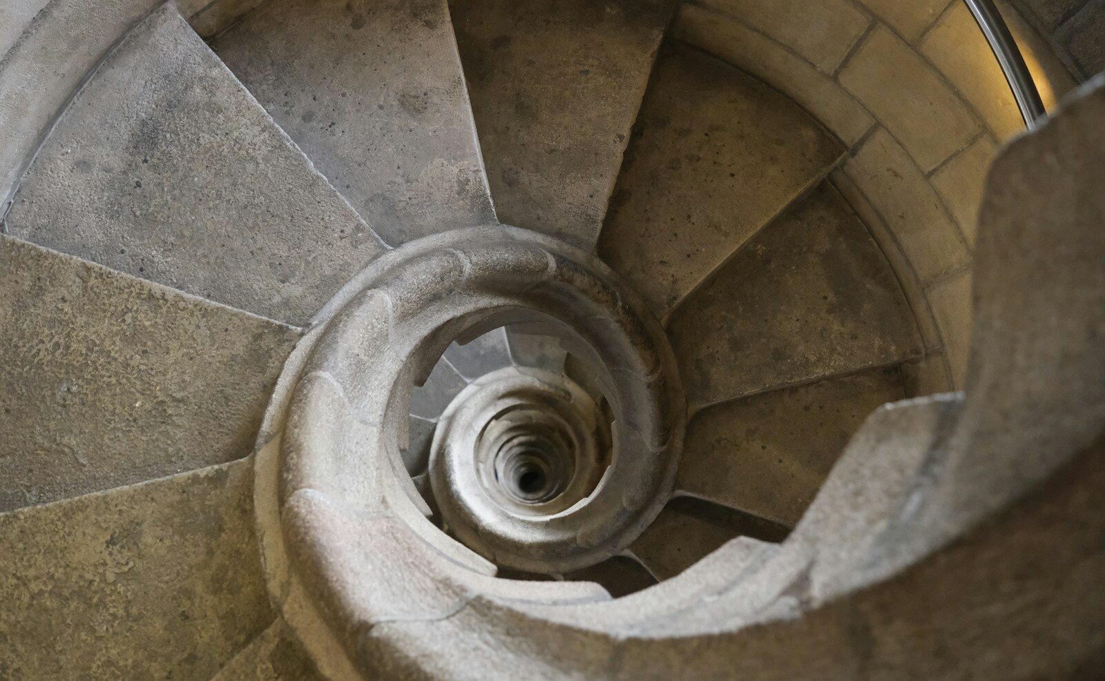a spiral staircase in a stone building
